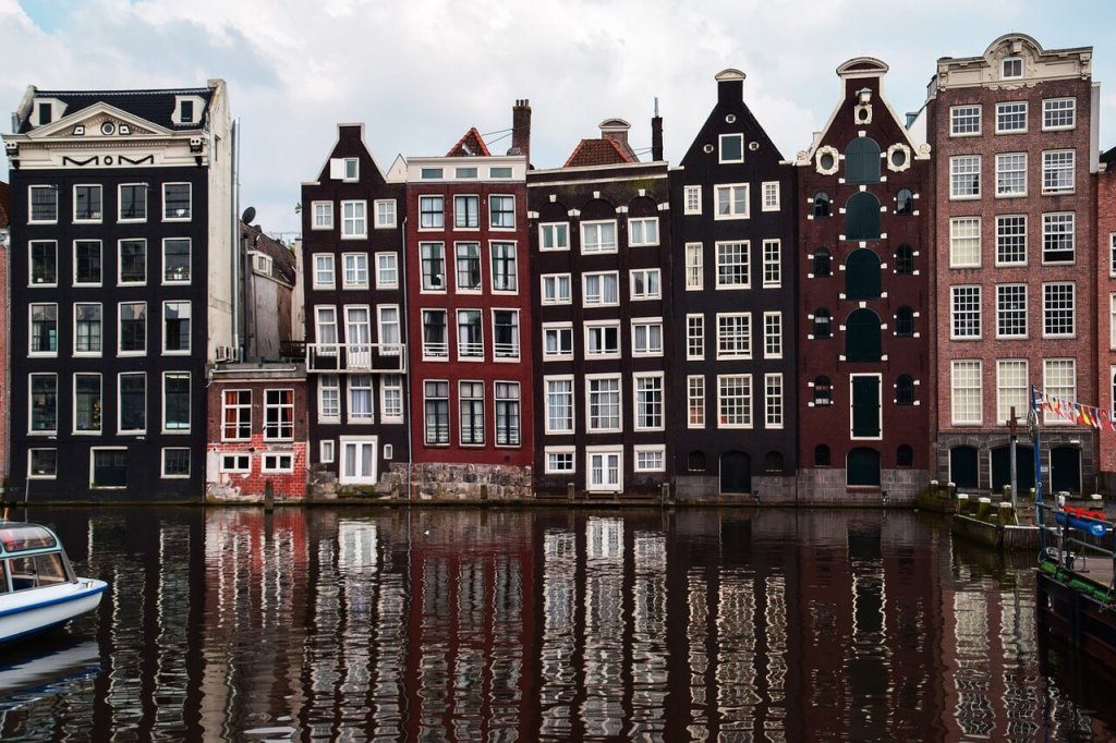 Amsterdam canal houses reflected in the water