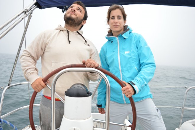 The sailing experts,looking at the mast and taking control