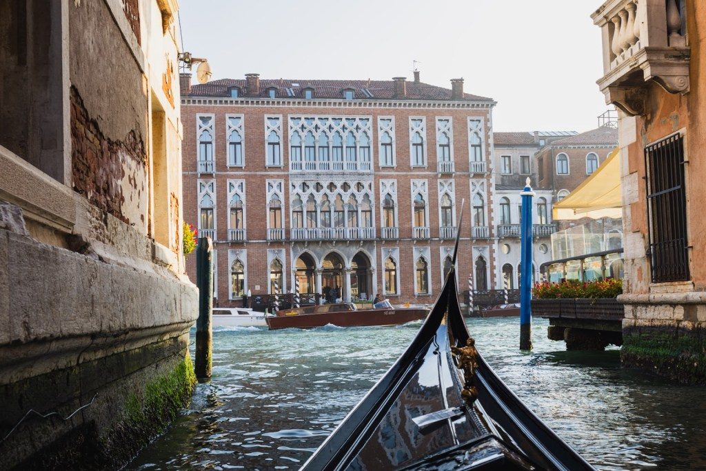 Wading through the wavy blue water on an elegant gondola in vENICE
